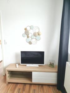 a flat screen tv sitting on top of a wooden entertainment center at Bogi's Ferienhaus - Pension in Laakirchen
