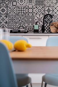 a kitchen with black and white tiles on the wall at Apartamenty Dune in Jastarnia