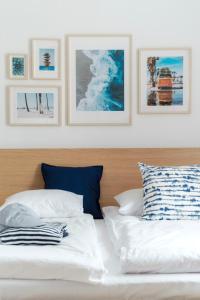 a bedroom with two beds and pictures on the wall at Apartamenty Dune in Jastarnia