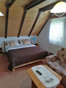 a bedroom with a large bed and a couch at House Jezerka in Jezerce +42 photos