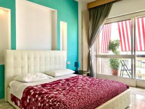 a bedroom with a bed with a large window at ROOM 110 BARI -guesthouse- in Bari