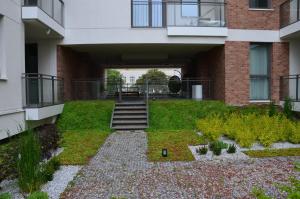 an external view of a building with a garden at Długie Ogrody Apartment 140 Gdańsk in Gdańsk