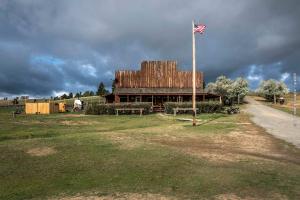 a barn with an american flag in front of it at lake guest ranch in Devils Tower +15 photos