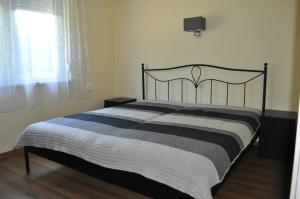 A bed or beds in a room at ZÁMOR HOLIDAY HOUSE