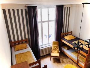 a room with two bunk beds and a window at Hostel Sova in Novi Sad