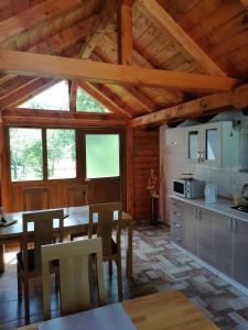 a kitchen with a table and chairs in a cabin at House Jezerka in Jezerce