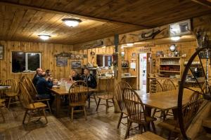 a group of people sitting at a table in a restaurant at lake guest ranch in Devils Tower