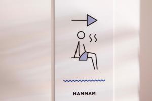 a sign that says hamman on a cell phone at Hôtel LOCOMO in Paris