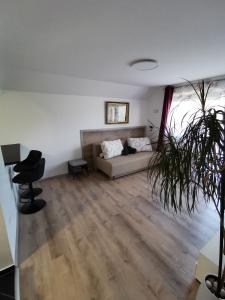 a living room with a couch and a plant at Apartments Bernard in Bled