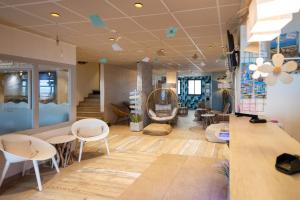 a store with chairs and tables in a room at The Originals Boutique, Hôtel Neptune, Berck-sur-Mer in Berck-sur-Mer