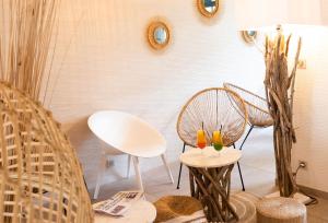 a room with chairs and a table with two glasses at The Originals Boutique, Hôtel Neptune, Berck-sur-Mer in Berck-sur-Mer