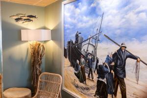 a mural in a room with a painting on the wall at The Originals Boutique, Hôtel Neptune, Berck-sur-Mer in Berck-sur-Mer