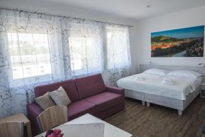 A bed or beds in a room at Apartmány Pemag Mikulov