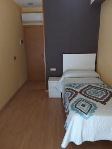 
A bed or beds in a room at Hostal Cal Siles
