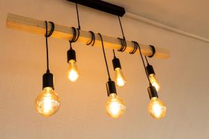 a group of light bulbs hanging from a ceiling at The Originals Boutique, Hôtel Neptune, Berck-sur-Mer in Berck-sur-Mer