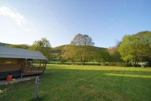 a tent in a field with mountains in the background at Safaritent op Camping Berkel in Bockholtz