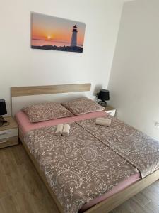 a bedroom with a bed and a lighthouse at Apartmani Bella Vista in Njivice