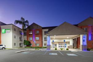 un aparcamiento de hotel frente a un hotel en Holiday Inn Express & Suites - Tulare, an IHG Hotel en Tulare