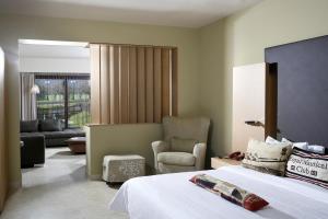 a hotel room with a bed and a chair at Elite City Resort in Kalamata