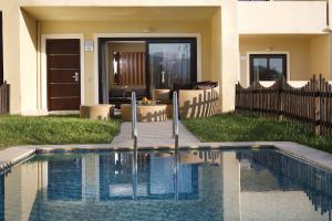 a swimming pool in the backyard of a house at Elite City Resort in Kalamata