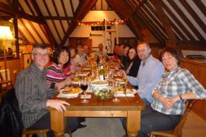 a group of people sitting at a table eating food at Brackenborough Hall Coach House - Granary in Louth