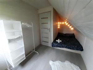 a small room with a bed and a closet at Domek nad stawem in Łabowa