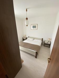 מיטה או מיטות בחדר ב-Condominio Aquilone