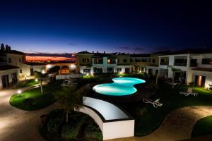 an overhead view of a swimming pool at night at Sagres Time Apartamentos in Sagres