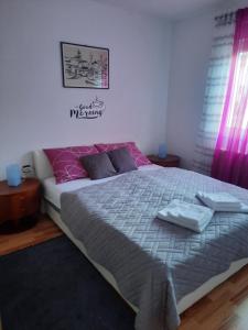 a bedroom with a bed with two towels on it at Apartman Trio Maksimir in Zagreb
