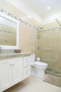 a bathroom with a toilet and a glass shower at Choose To Be Happy at Surbiton Square - Two Bedroom Townhouse in Kingston +29 photos