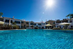 a large swimming pool in front of a building at Sagres Time Apartamentos in Sagres