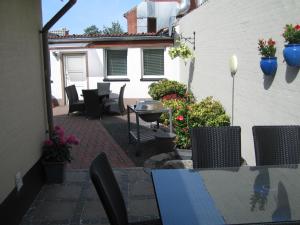 a patio area with a table and chairs at Amalie Bed and Breakfast & Apartments in Odense