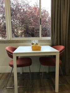 a white table with two chairs and a window at Romantic 1 Bedroom Apartment at Roma Avenue - 1C in Lisbon