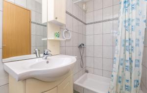 a bathroom with a sink and a shower at Apartments Franelli in Brseč +50 photos