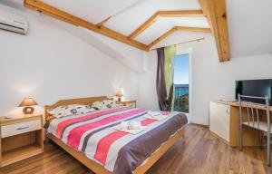 a bedroom with a large bed and a television at Apartments Franelli in Brseč