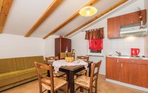 a kitchen and dining room with a table and chairs at Apartments Franelli in Brseč