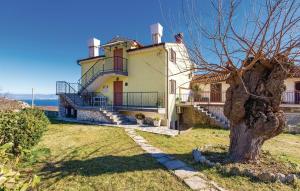 a large house with a tree in front of it at Apartments Franelli in Brseč