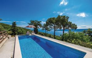a swimming pool with a view of the ocean at Apartments Franelli in Brseč