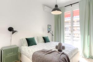 a bedroom with a bed and a large window at #29 Suite Gambetta AC Sea view 2 bedrooms 1min Walk to Promenade & Sea in Nice