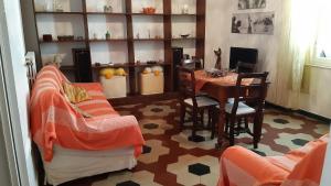 a living room with a table and chairs and a dining room at Apartment Cecina in Cecina