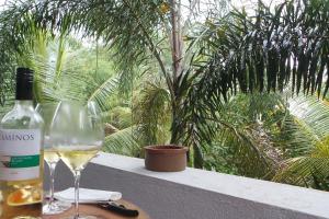 a bottle of wine and a glass on a table at Luxury villa Costanza in Hikkaduwa