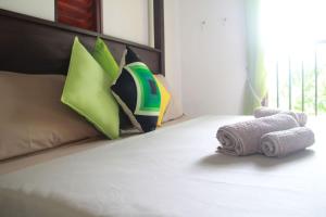 a bed with two rolls of towels on it at Luxury villa Costanza in Hikkaduwa +36 photos