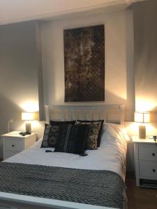 a bedroom with a bed with pillows and two lamps at Villa Aragvi in Mtskheta +45 photos