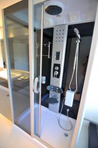 a room with a shower and a hair dryer at Altos del Arapey All Inclusive, Golf & Spa in Termas del Arapey
