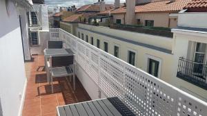 an apartment balcony with a bench and buildings at Feelathome San Marcos Apartments in Madrid