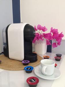 a coffee maker and a cup of coffee on a counter at B&B Campitur in Campomarino