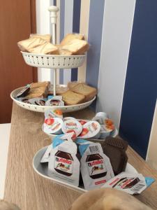 a plate with food on a table with a basket at B&B Campitur in Campomarino