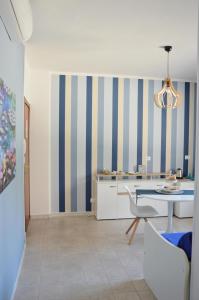 a kitchen with blue and yellow striped walls and a table at B&B Campitur in Campomarino