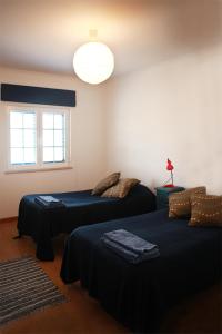 Postel nebo postele na pokoji v ubytování Casal Do Góis Guest House