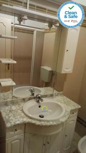 a bathroom with a sink and a mirror at Sol e Praia - Peniche I in Peniche